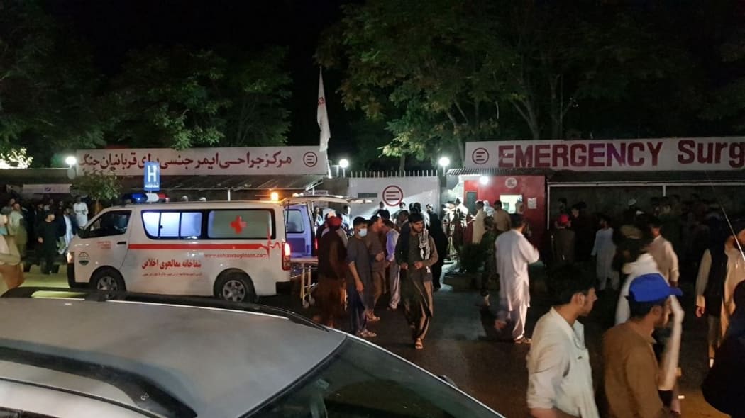 KABUL, AFGHANISTAN - AUGUST 26: Injured people being carried to a hospital as unspecified number of casualties reported after two explosions outside Hamid Karzai International Airport in Kabul, Afghanistan on August 26, 2021.