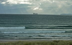 Ship cruising south past Mount Maunganui.