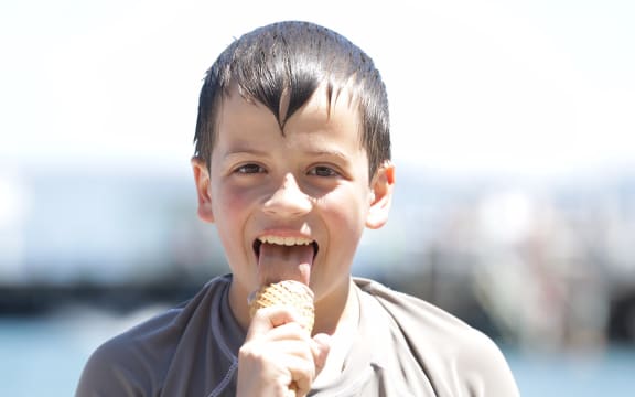 A beachgoer enjoying an ice cream.