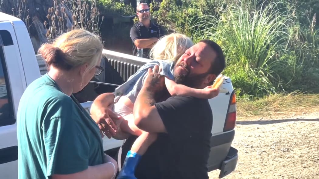 Glenn hugs son Axle after the three-year-old was found following an overnight search