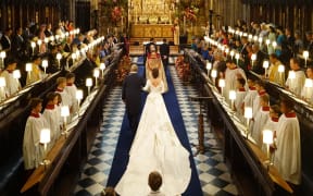 Britain's Princess Eugenie of York (C) walks up the aisle to marry Jack Brooksbank during their wedding ceremony in St George's Chapel, Windsor Castle.