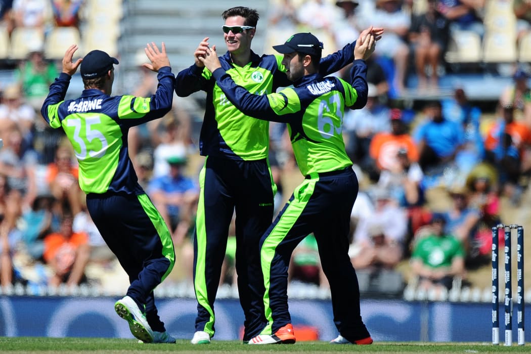 Ireland player George Dockrel celebrates the wicket of West Indies player Denesh Ramdin.