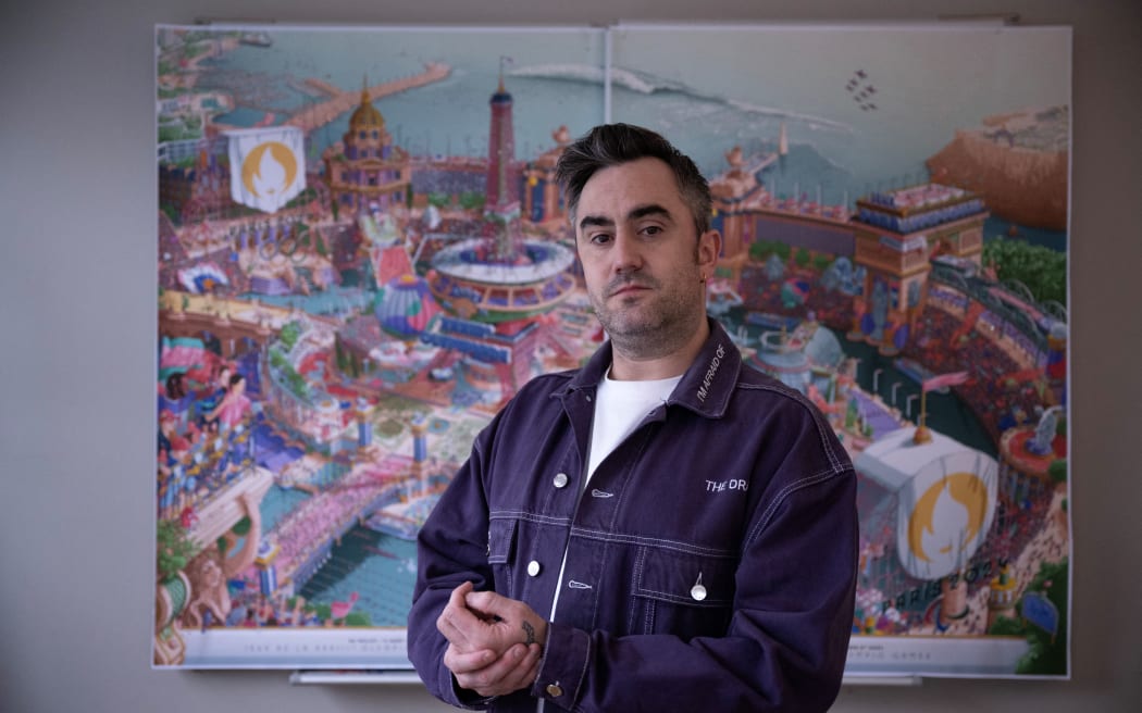 French artist Ugo Gattoni poses ahead the Paris 2024 Olympic and Paralympic Games official posters in his workshop in Ivry sur seine, near Paris, on February 1, 2024. (Photo by JULIEN DE ROSA / AFP) / RESTRICTED TO EDITORIAL USE - MANDATORY MENTION OF THE ARTIST UPON PUBLICATION - TO ILLUSTRATE THE EVENT AS SPECIFIED IN THE CAPTION