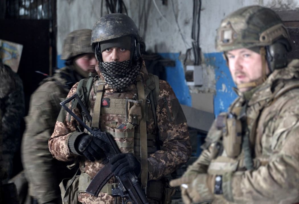 Servicemen of the Ukrainian Military Forces wait out the shelling in a shelter on a position in the Lugansk region on March 5, 2022.