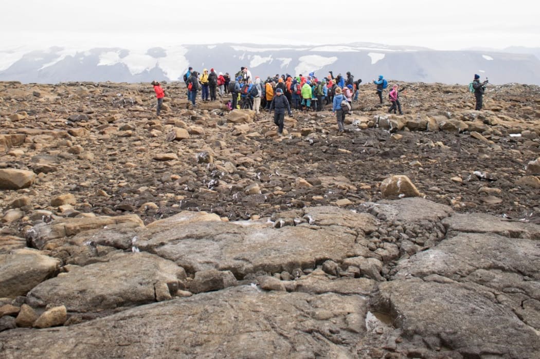 People attend a monument unveiling at site of Okjokull, Iceland's first glacier lost to climate change.