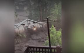 The moment a house was swept away by floodwaters in New Mexico was captured on video widely shared on social media.