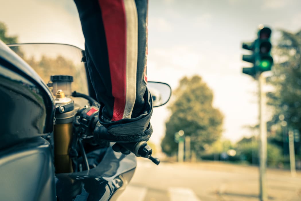 Motorcyclist on the road - Racing motorbike stops at traffic lights