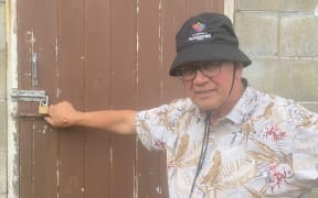 John Hooker with the locked pump station which is nitrate-contaminated