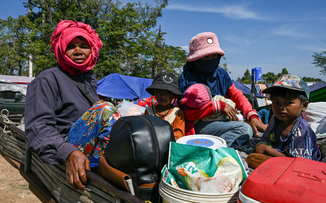 Residents gather outside a temple after they evacuated following clashes along the Cambodia-Thailand border, in Siem Reap province on December 9, 2025. Two more Thai soldiers were killed on December 9, in renewed border clashes with neighbour Cambodia, the Thai army said, raising the death toll for Thai troops to three. (Photo by TANG CHHIN SOTHY / AFP)