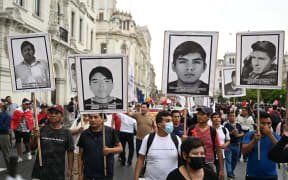 Protestors hold banners with portraits of victims of past protests during a demonstration against the government of Peruvian President Dina Boluarte in Lima on January 4, 2023. - Political upheaval has roiled Peru in the last weeks. Then-president Pedro Castillo on December 7 sought to dissolve Congress and rule by decree, only to be ousted and thrown in jail. Castillo was replaced by his vice president, Dina Boluarte. But Boluarte has faced a wave of often violent demonstrations calling for Castillo to be returned to power. (Photo by ERNESTO BENAVIDES / AFP)