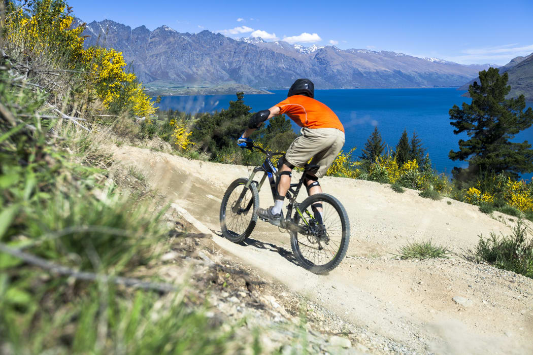 Mountain bike rider on bike path in Queenstown, New Zealand