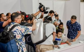 The man of the moment - Fiji's supervisor of elections Mohammed Saneem (far right) fronts a media scrum for an elections update in the capital Suva. 17 December 2022
