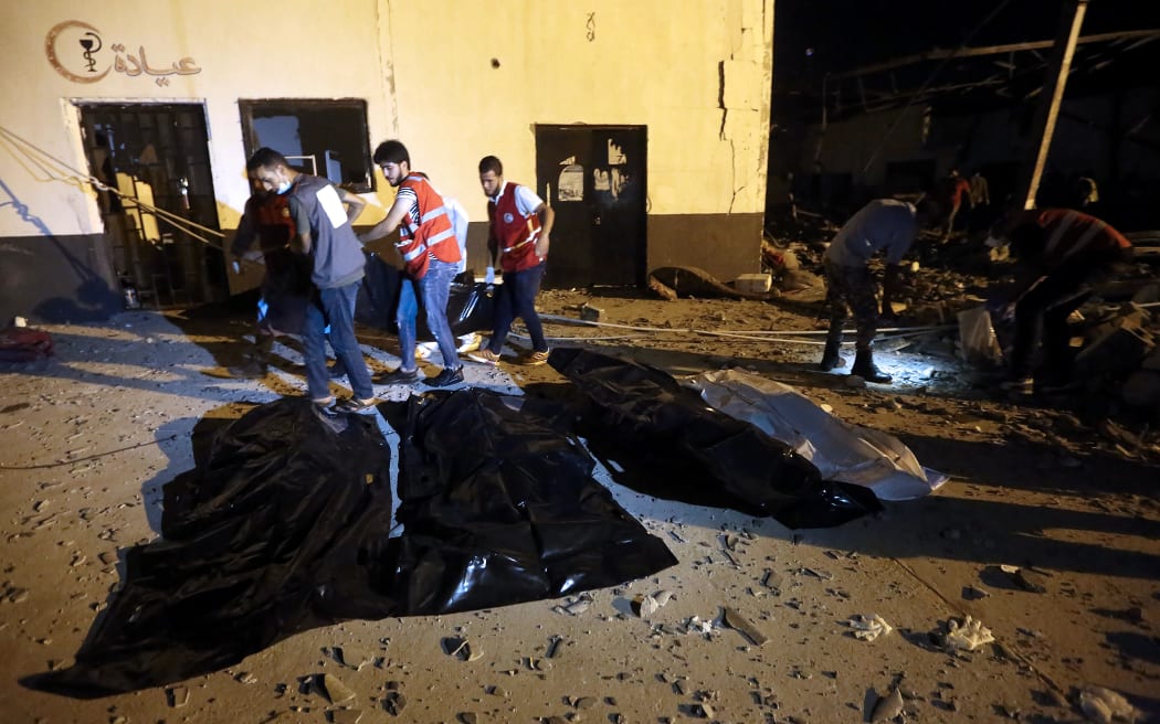 Emergency workers recover bodies after an airstrike killed nearly 40 at Tajoura Detention Center, east of Tripoli on early July 3, 2019.