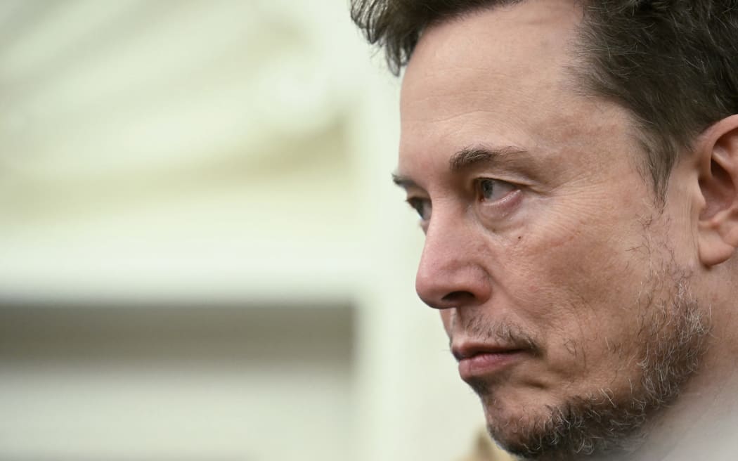 Co-leader of the Department of Government Efficiency Elon Musk looks on as US President Donald Trump meets with South African President Cyril Ramaphosa in the Oval Office of the White House in Washington, DC, on May 21, 2025. South African President Cyril Ramaphosa meets Donald Trump on Wednesday amid tensions over Washington's resettlement of white Afrikaners that the US president claims are the victims of "genocide."
