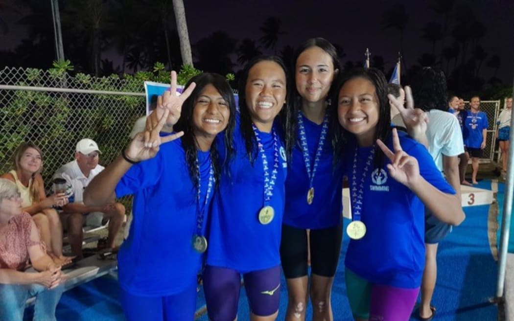 From left, the CNMI’s Sari Barman, Shoko Litulumar, Frances Raho, and Maria Batallones pose after their gold medal-winning swim in the women’s 800-yard freestyle in the 2024 Micronesian Games yesterday in the Kwajalein Pool in Kwajalein, Marshall Islands.