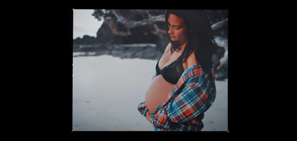 A pregnant Shayni Crouch cradles her stomach.