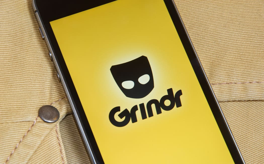 KRIVOY ROG, UKRAINE - JANUARY 9, 2016: iPhone 5s with mobile application for Grindr on the screen in orange jeans pocket