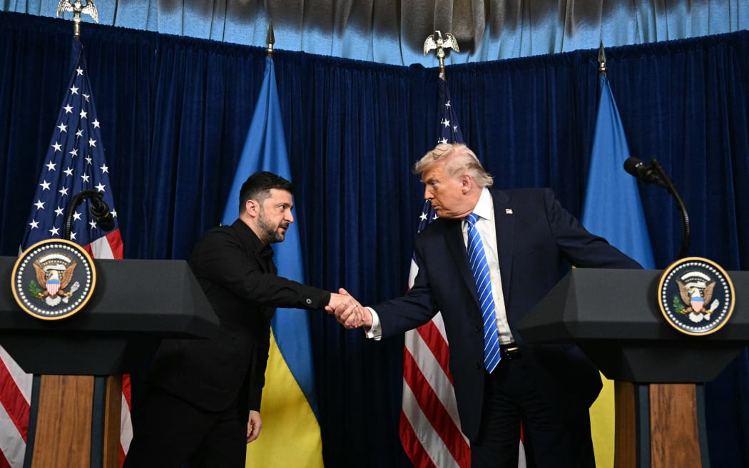 US President Donald Trump and Ukranian President Volodymyr Zelensky shake hands during a press conference following talks at Trump's Mar-a-Lago residence in Palm Beach, Florida, on December 28, 2025.