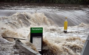 A ferry terminal is submerged by the overflowing Parramatta river in Sydney.