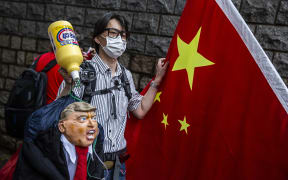 A pro-China activist holds an effigy of US President Donald Trump during a protest outside the US consulate in Hong Kong on May 30, 2020, in response to Trump's sanctions pledge.