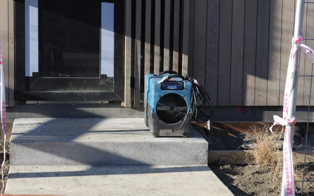 Commercial dehumidifiers were visible in the windows of at least eight homes.
