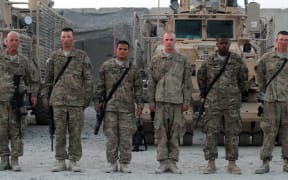Micronesian soldier SGT Kilfrank Sigrah stands at attention in Kandahar, Afghanistan.
