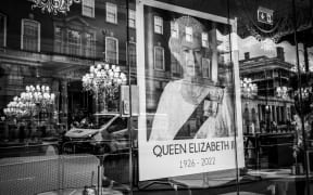 (EDITOR’S NOTE: Image was converted to black and white) A poster of Queen Elizabeth II near the Palace of Westminster on September 15, 2022 in London, England. Queen Elizabeth II died at Balmoral Castle in Scotland on September 8, 2022, and is succeeded by her eldest son, King Charles III.(Photo by Carolina Rapezzi/NurPhoto) (Photo by Carolina Rapezzi / NurPhoto / NurPhoto via AFP)