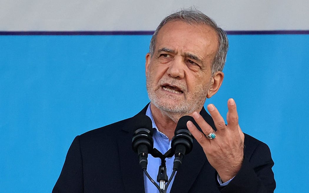 Iran's President Masoud Pezeshkian delivers a speech during the annual military parade marking the anniversary of the outbreak of the 1980-1988 war with Saddam Hussein's Iraq, in Tehran on September 21, 2024. (Photo by ATTA KENARE / AFP)