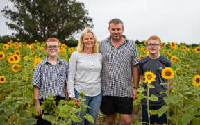 The Rayner family runs The Gladstone Sunflower Patch as a way to raise money for their sons' hockey team.