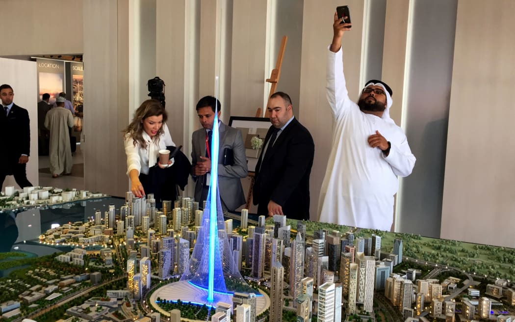 Visitors look at a to-scale model of the planned Dubai Emaar Properties tower.