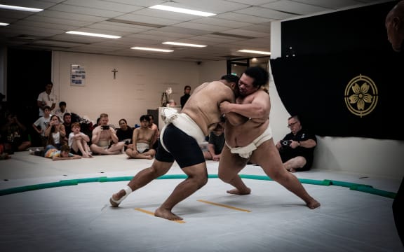 Sumo wrestler Filipo Chanel Tovio (right) is the two-time Oceania Heavyweight Champion.