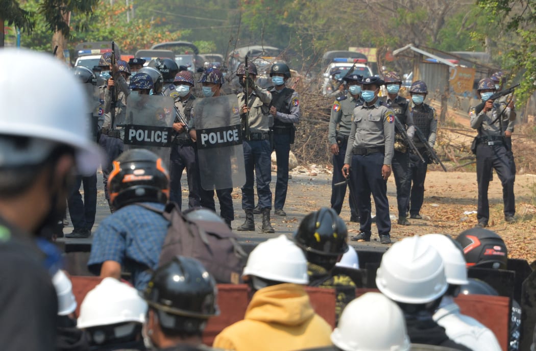 Riot police hold their firearms as they face off with protesters during a demonstration against the military coup in Naypyidaw.