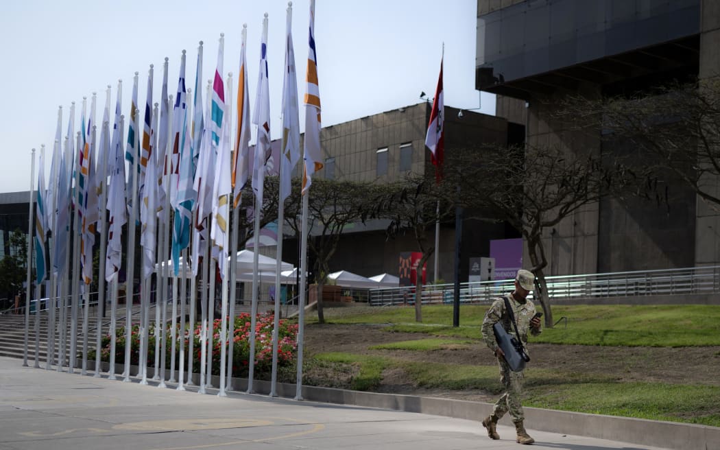 A member of the air force walks past the government complex where the Asia-Pacific Economic Cooperation (APEC) Summit will take place in Lima on November 13, 2024. - Leaders and representatives of the APEC 21 member economies and other commercial guests will meet in Lima from November 14 to 16. (Photo by Luis ACOSTA / AFP)