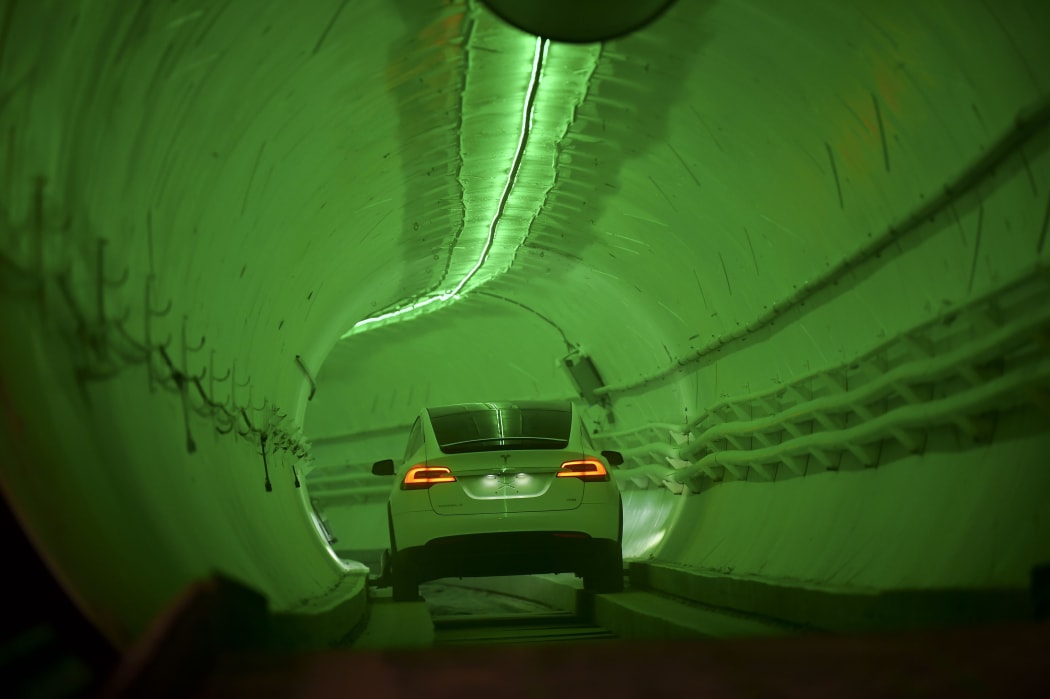 A modified Tesla Model X drives into the tunnel entrance before an unveiling event for the Boring Co.