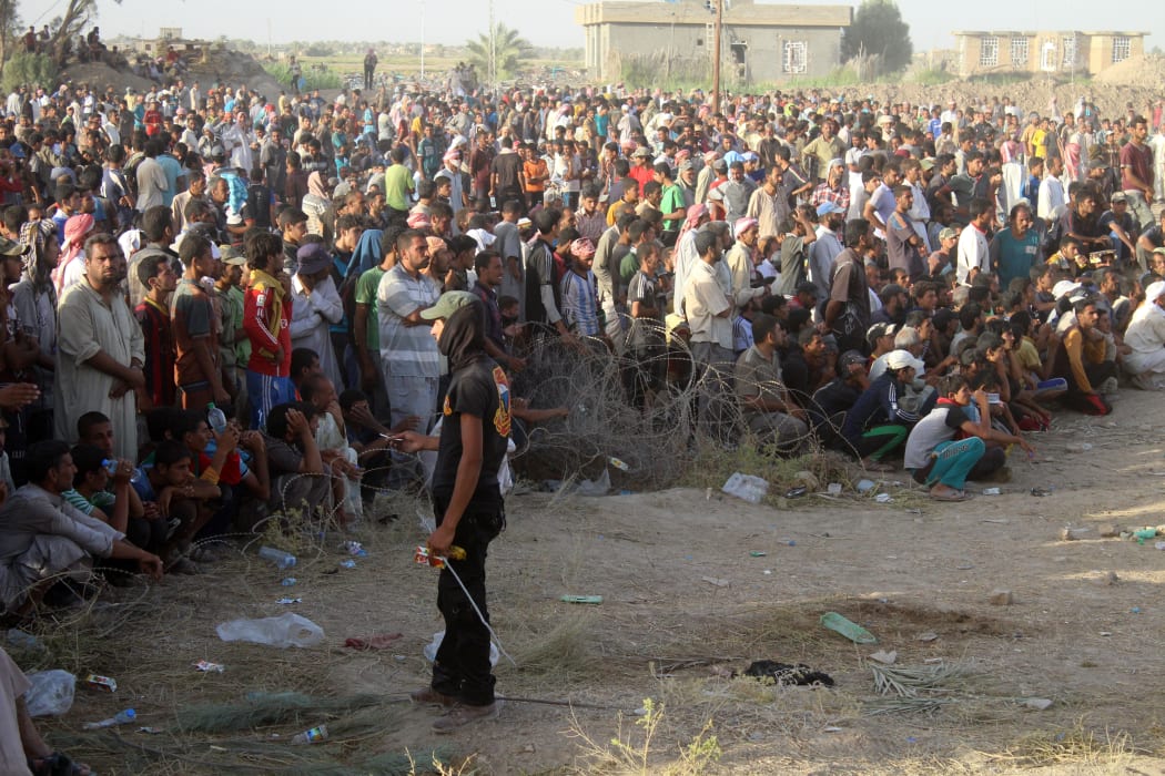 Displaced Iraqis from the city of Fallujah rest at a safe zone on June 17, 2016 in Amiriyiah al-Fallujah,