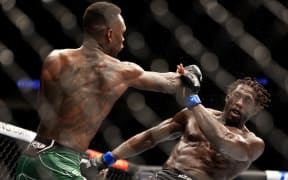 LAS VEGAS, NEVADA - JULY 02: Israel Adesanya (L) of Nigeria punches Jared Cannonier in their middleweight title bout during UFC 276 at T-Mobile Arena on July 02, 2022 in Las Vegas, Nevada.   Carmen Mandato/Getty Images/AFP (Photo by Carmen Mandato / GETTY IMAGES NORTH AMERICA / Getty Images via AFP)