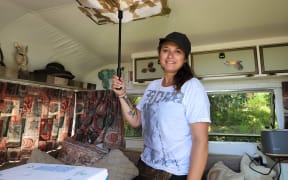 Muriwai resident Teena Stevens says their caravan has survived a summer of successive weather events and is still holding out strong, with a blunt umbrella plugging a hole in the roof.