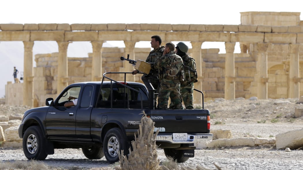 Members of the Syrian army patrol the ancient Syrian city of Palmyra on 6 May 2016.