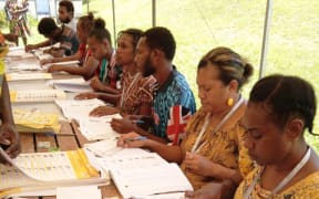 Electoral officers confirm voters’ eligibility to vote in Vanuatu’s snap election, pictured on Jan. 16, 2025.