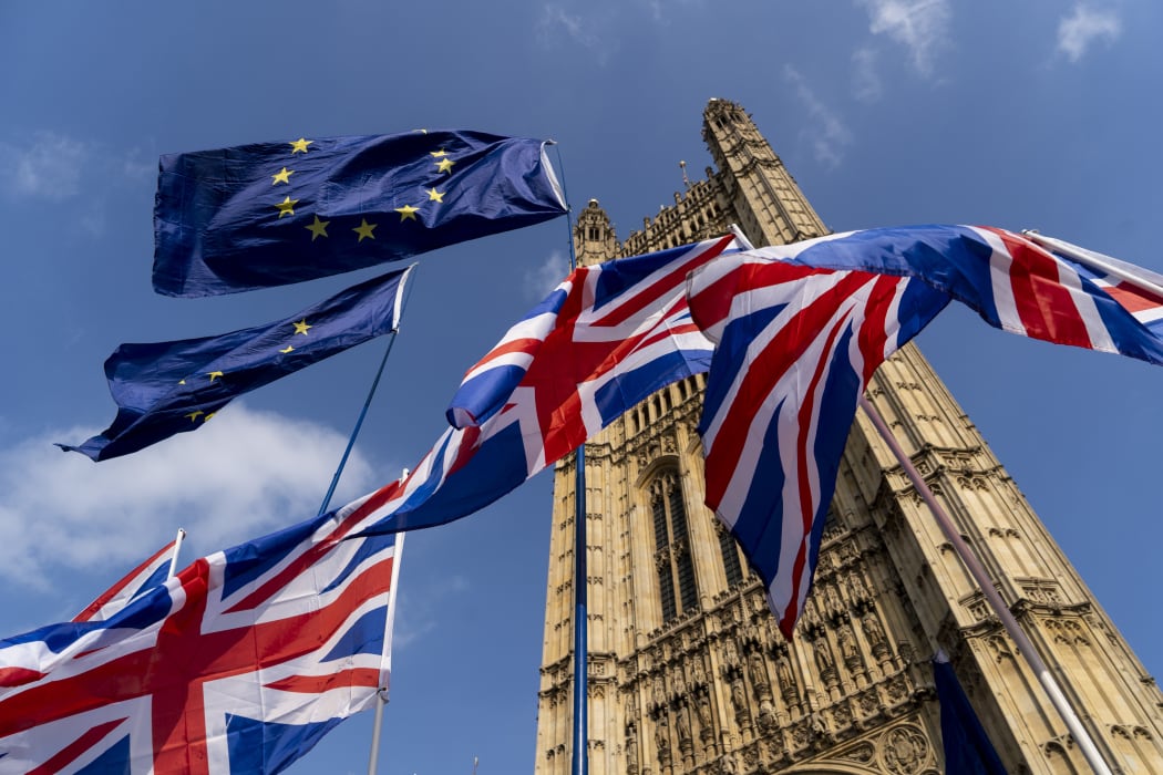 (FILES) In this file photo taken on March 28, 2019 Union and EU fags flutter outside the Houses of Parliament in Westminster, London.