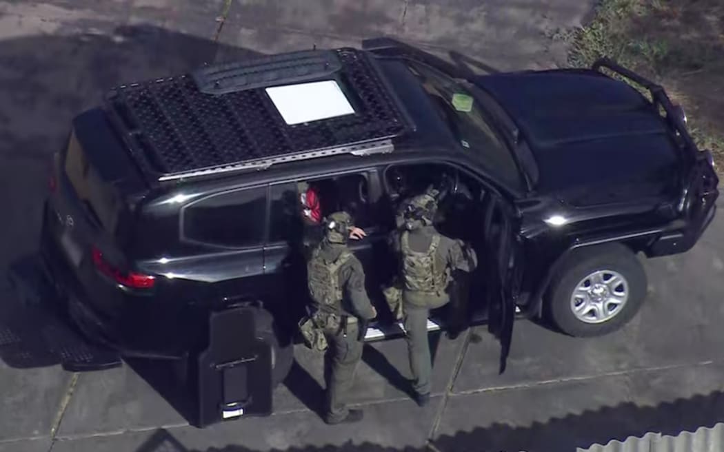 Tactical police outside the man's house in Warwick.