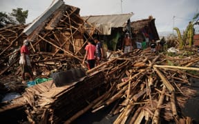 Residents salvage belongings from their destroyed homes in the coastal town of Dulag in Leyte province.