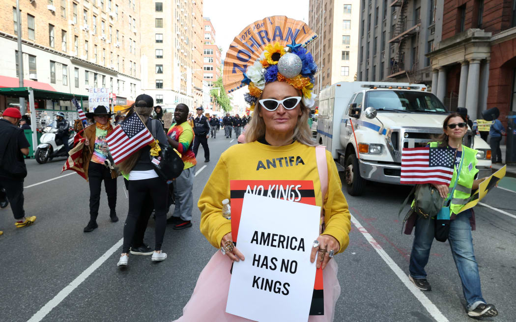 A person participates in a "No Kings" national day of protest in New York on October 18, 2025. From New York to San Francisco, millions of Americans are expected to hit the streets to voice their anger over President Donald Trump's policies at nationwide "No Kings" protests. (Photo by TIMOTHY A.CLARY / AFP)