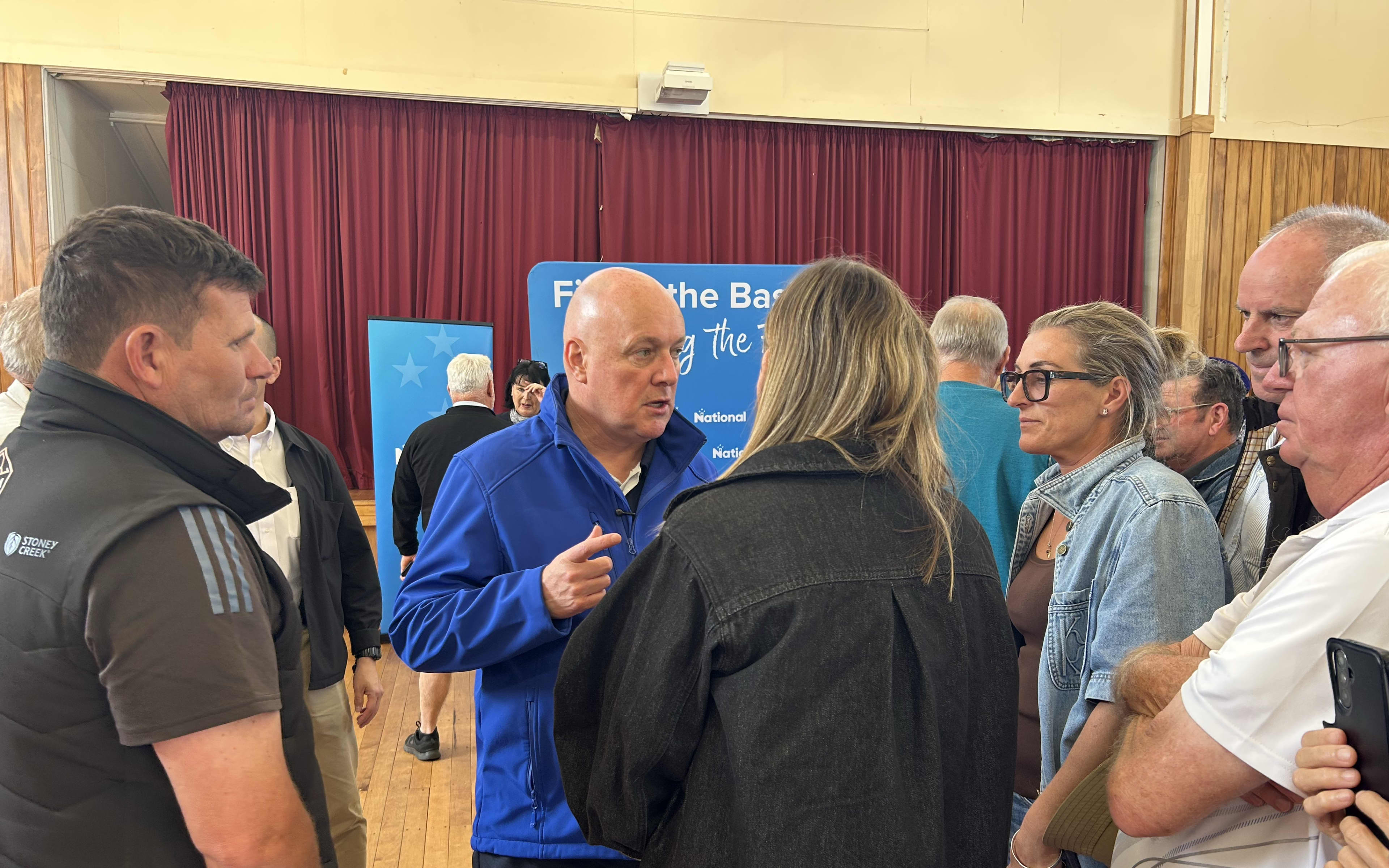 National Party leader Christopher Luxon talks to people after a public meeting at Pongakawa Hall on 21 October 2026.
