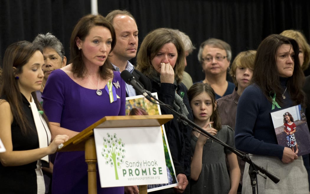 (FILES) In this file photo taken on January 14, 2013 family members of victims of the Sandy Hook Elementary School shooting attend a news conference in Newtown, Connecticut. -