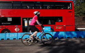 A cyclist rides along a section of the Mayor of London's 'Streetspace' scheme, designed to expand capacity for pedestrians and cyclists on certain roads while social distancing guidelines remain in effect, on Park Lane in London, England, on May 28, 2020.