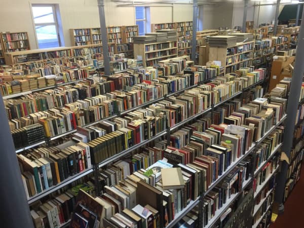 Rows of shelves of second hand books at Hard to Find Books store.