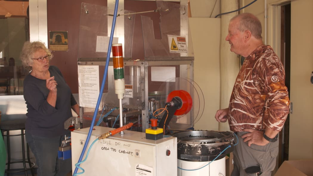 Carolyn Livingstone and Brian Frances (Skin) at the poppy making machine.