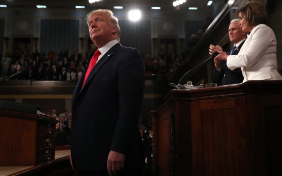 US President Donald Trump arrives, with Vice President Mike Pence and Speaker of the House Nancy Pelosi behind him, ahead of his third State of the Union address.