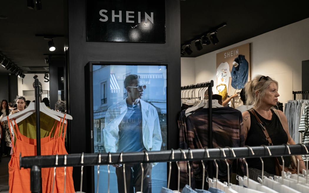 A customer looks at the clothes on display at a pop-up store of the Chinese-founded fast fashion brand Shein, in Dijon, France in June 2025.
